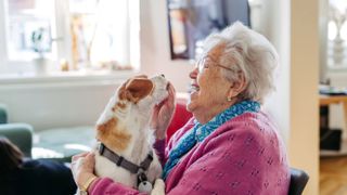 Woman giving dog a treat