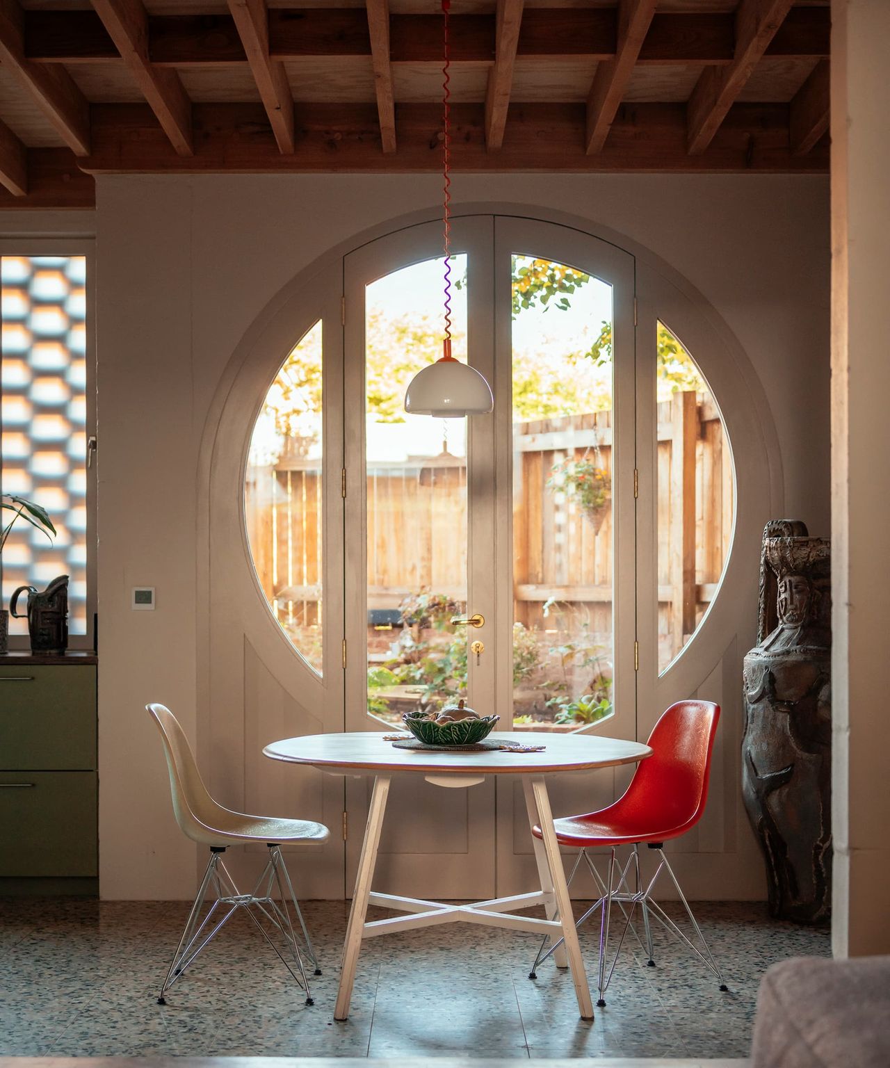 A sitting area next to a circular window