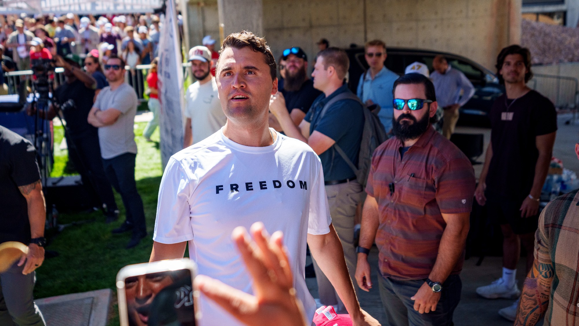 Charlie Kirk in a Freedom t-shirt on a college campus