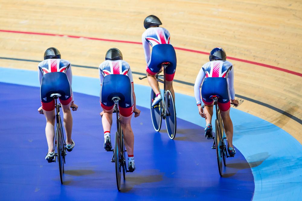 Members of the women's team emerge onto the track
