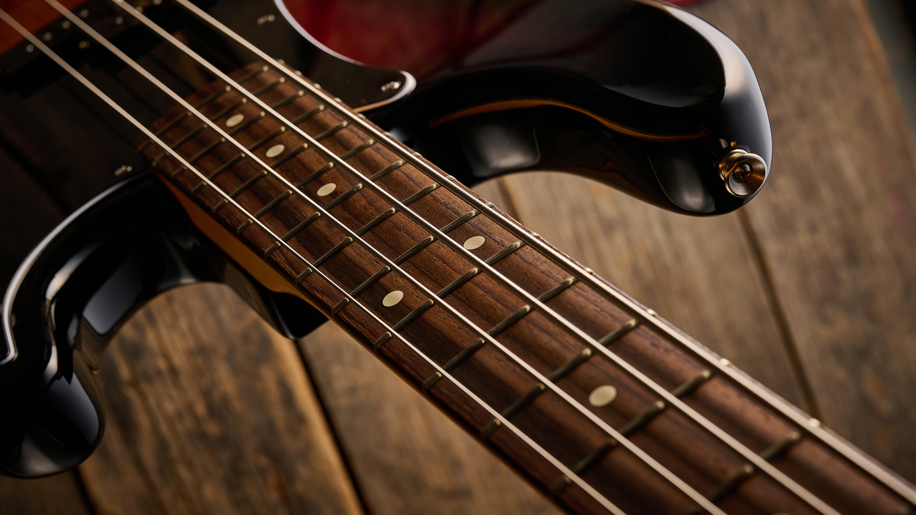 Fender American Professional Classic Precision Bass in 3-Color Sunburst shot on wood floor boards