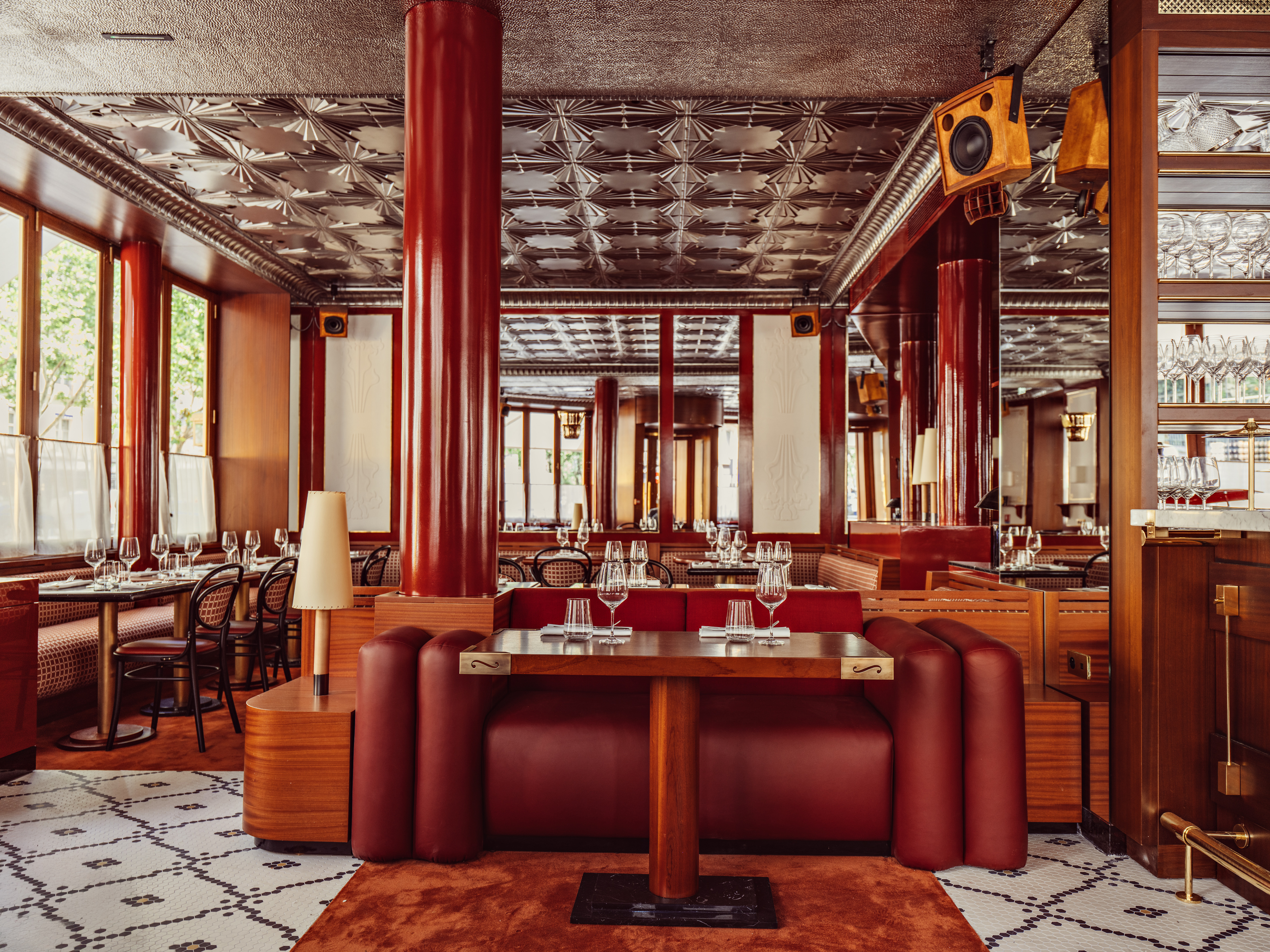 French restaurant with mosaic floors and rich burgundy furnishings