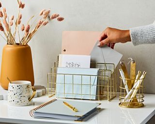 Desktop with gold grid desk organizers.