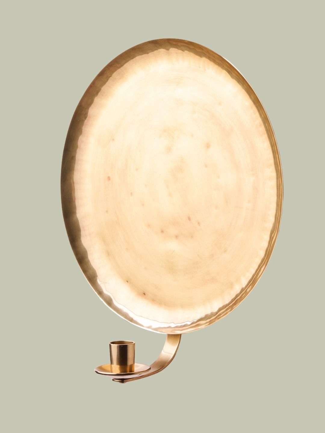 A gold outdoor candle sconce light on a soft sage green background.