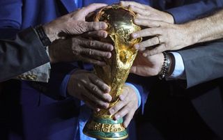 World Cup 2022 live stream: Hands touching the World Cup trophy