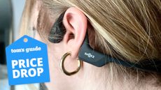 a photo of a member from the Tom's Guide team wearing the Shokz OpenRun Pro headphones