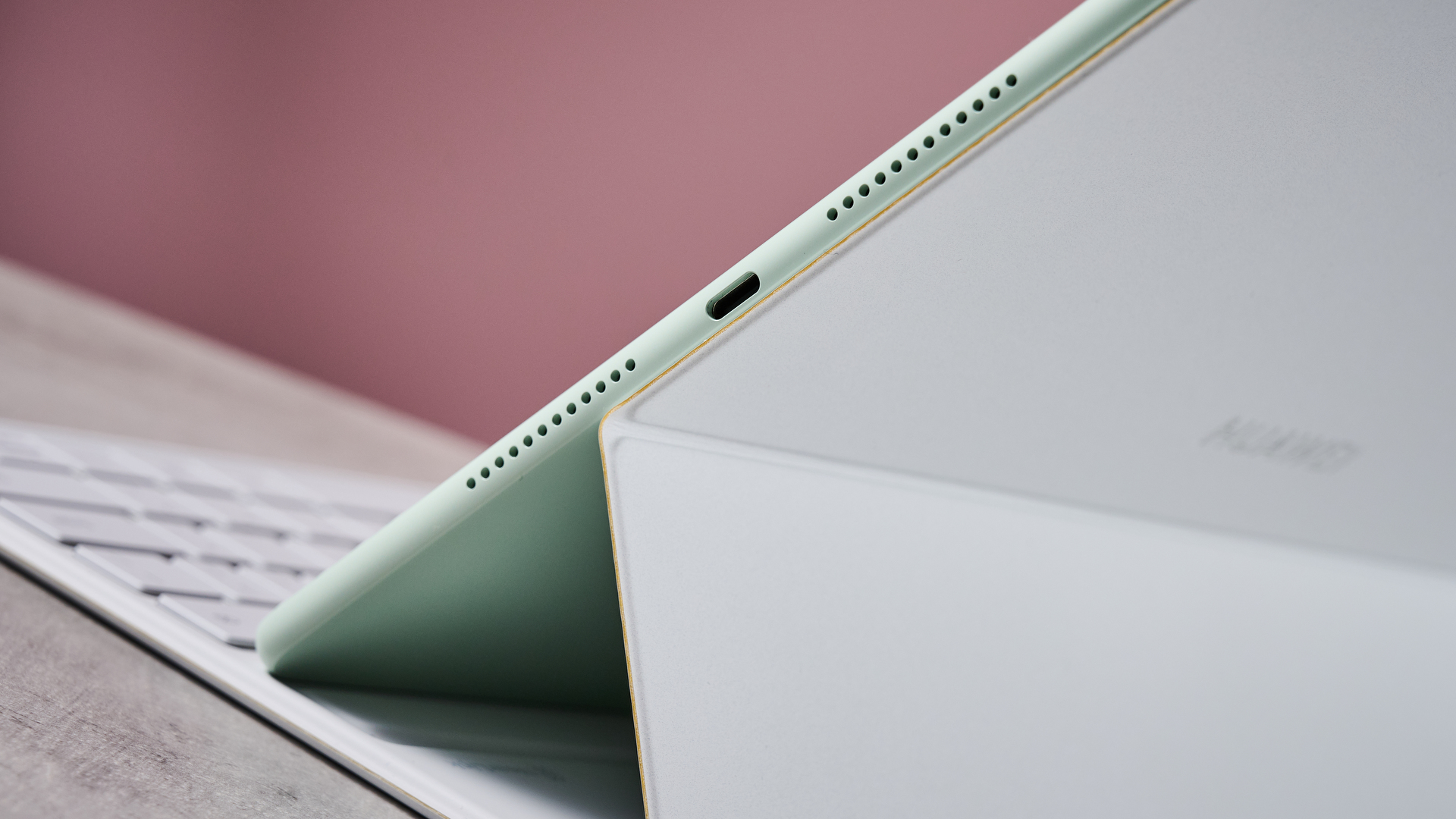 A closeup of the Huawei MatePad 12X 2025's speakers at the bottom of the device, with a section of the keyboard showing in the background.