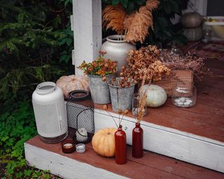 Autumn wooden porch or patio with bottles, jars, family heirlooms