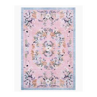 A pink and blue vintage-style rug with florals