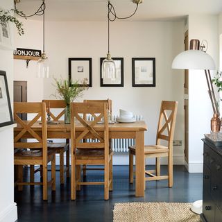 dining room with frames on wall and dining table
