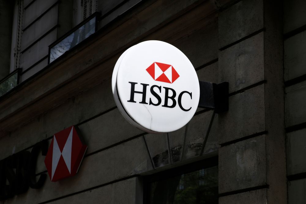 Round HSBC sign on the wall of a bank building.