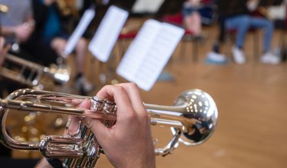 A closeup on a student playing a trombone