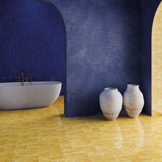 A Marrakesh style bathroom with bright yellow tiled floors and blue walls