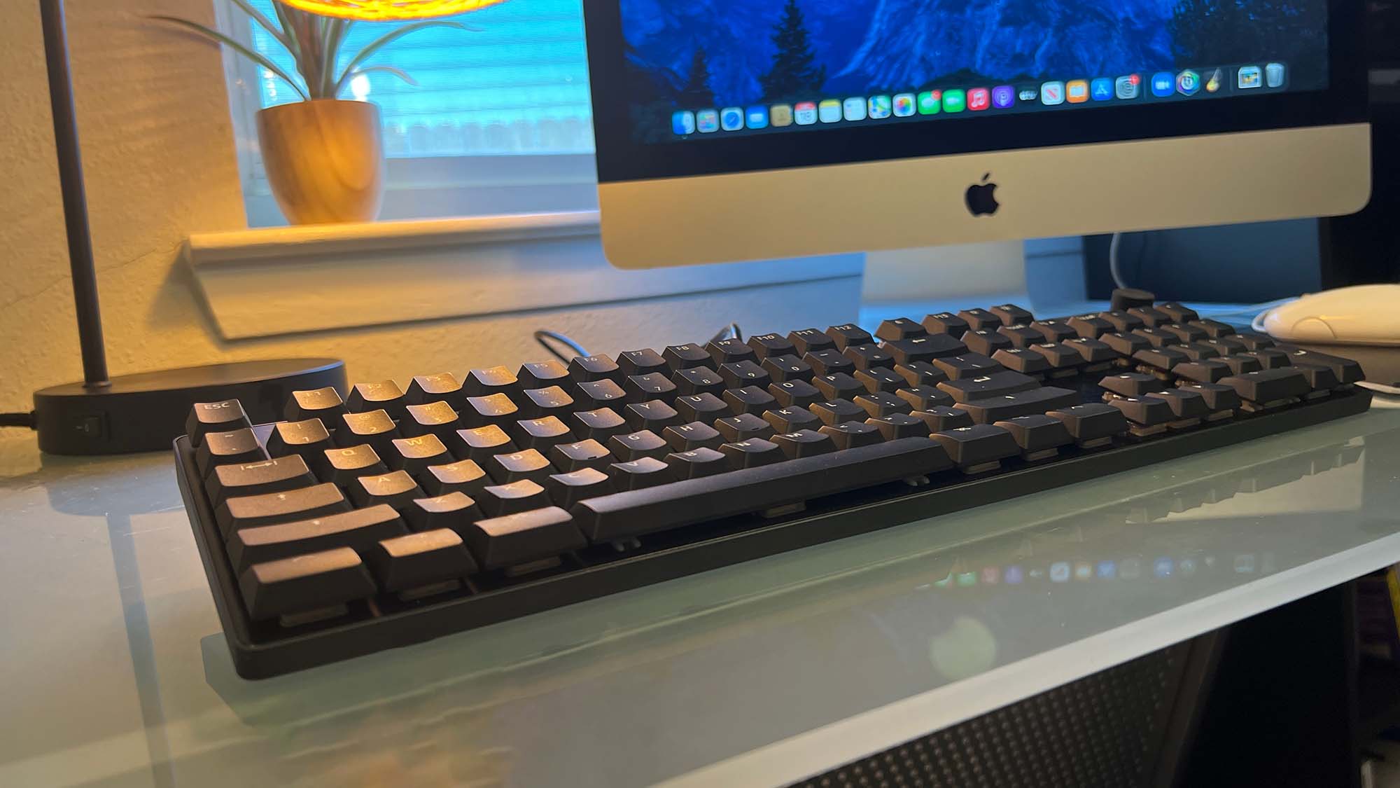 A Das Keyboard MacTigr on a glass-top desk