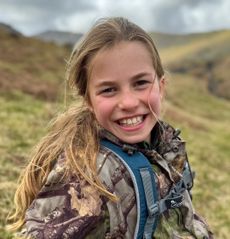 Princess Charlotte smiling wearing a camouflage Jacket on her 10th birthday