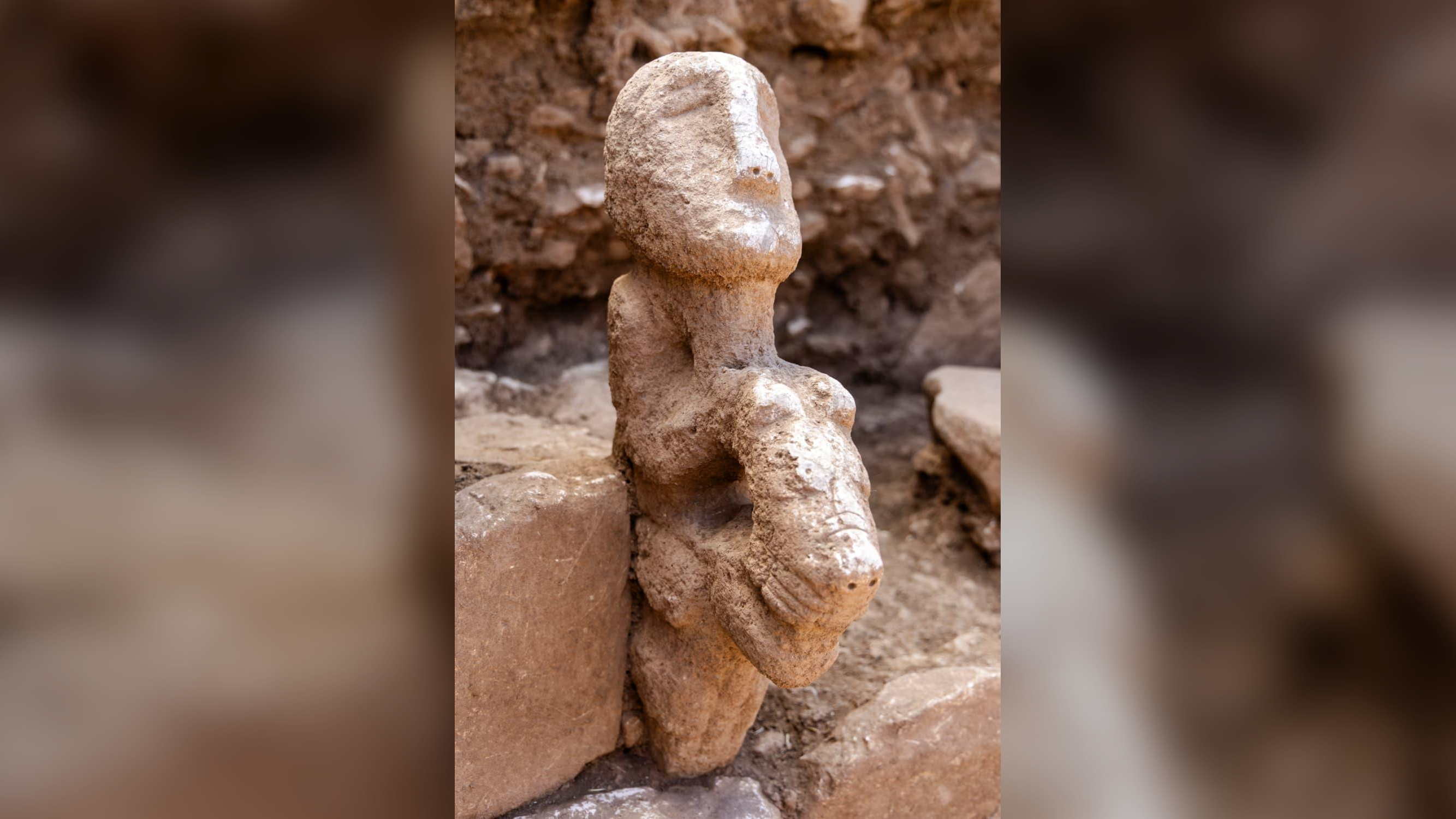 a carved stone statue resembling a person riding a leopard
