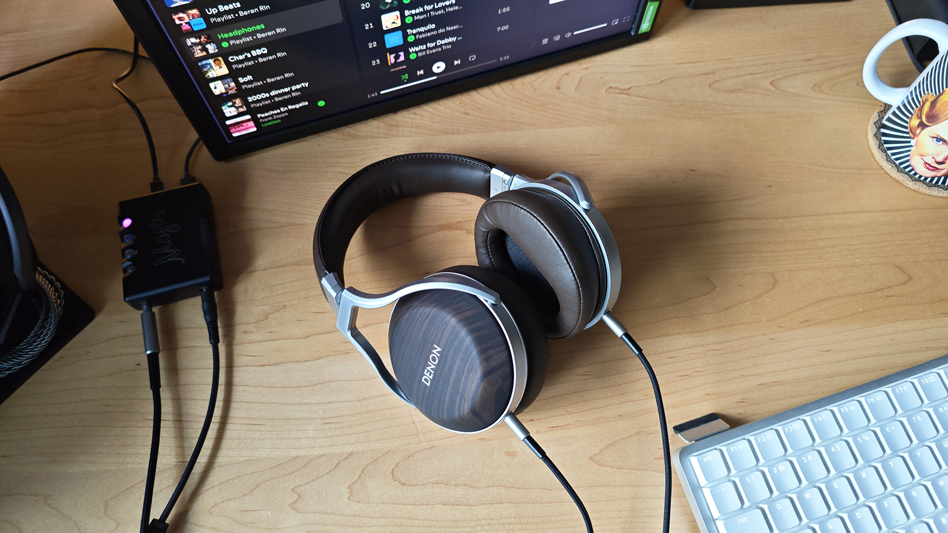 The Denon AH-D5200 and other headphones, photographed on a home desktop. 