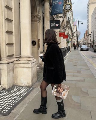 @tia_dewitt wearing skirt, tights, jacket and biker boots