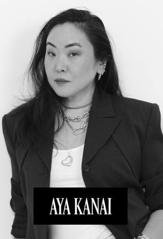 Former editor in chief of Marie Claire Aya Kanai wearing a black blazer and white t-shirt and multiple gold necklaces