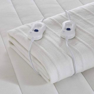 An electric blanket with dual controls