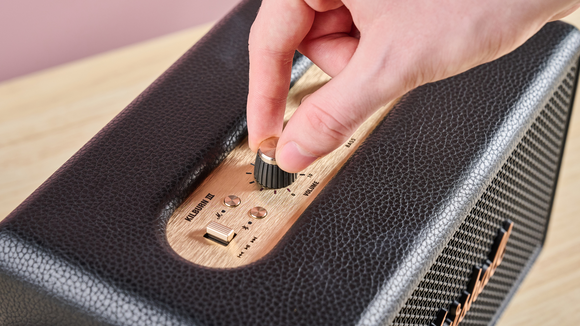Person turning a knob on the Marshall Kilburn III