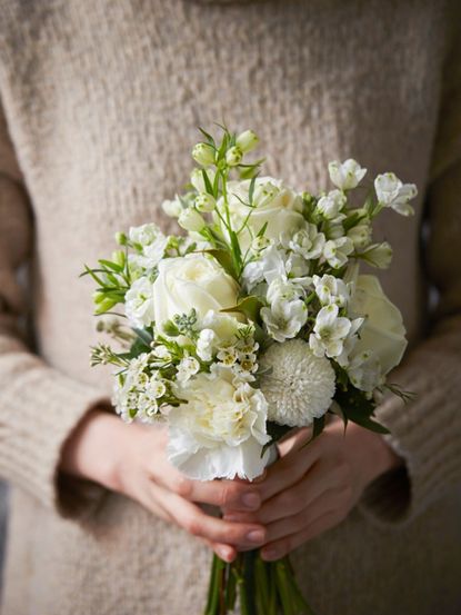 Person Holding A Bouquet Of Gorgeous White Flowers