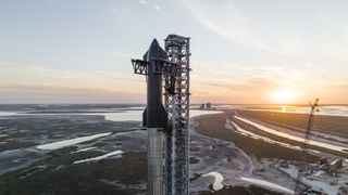 SpaceX's first orbital Starship rocket stands atop its Super Heavy booster at the company's Starbase test site near Boca Chica Beach in South Texas.