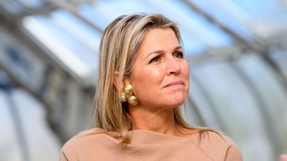 Queen Maxima's red wine nails were the perfect pop of colour as the Queen of the Netherlands stepped out in an all beige ensemble