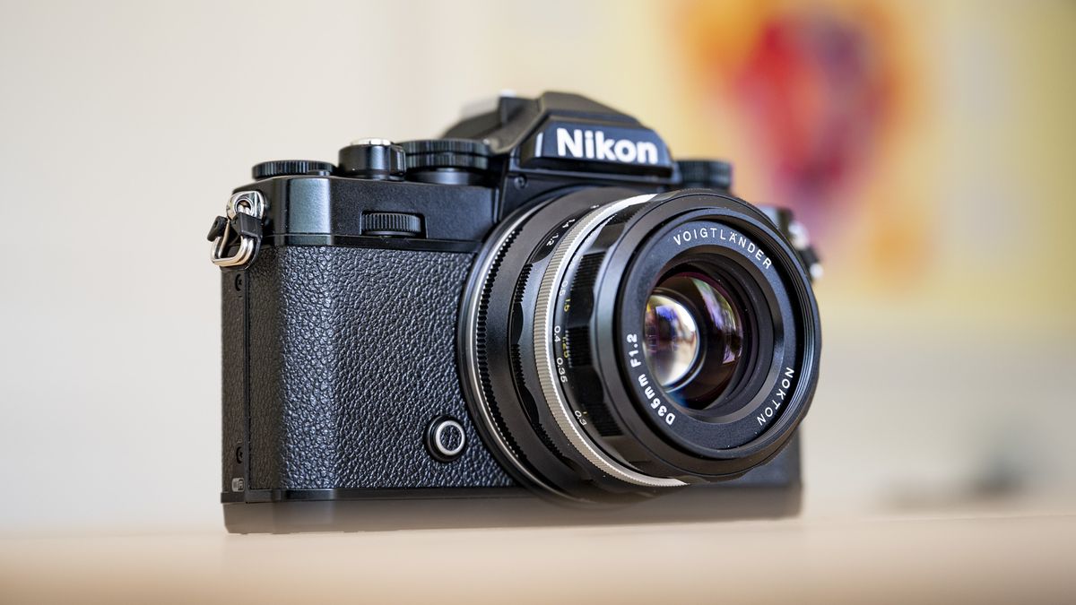 Voigtlander D 35mm f1.2 Nokton lens on a wooden table attached to a Nikon Z fc