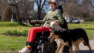 Woman in wheelchair with two dogs
