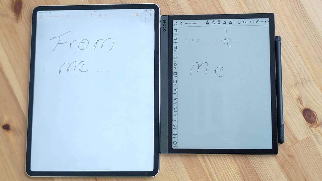 The Onyx Boox Tab Ultra C next to an iPad Pro on a wooden table