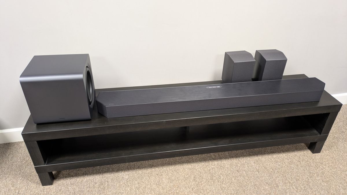 Samsung HW-Q990F soundbar, subwoofer and speakers on a dark bench