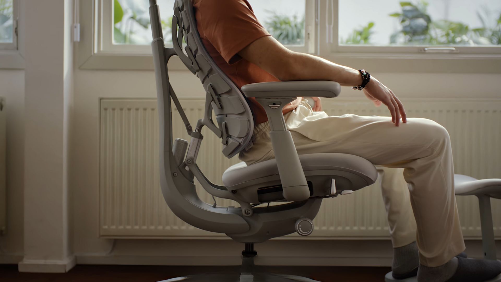 A screenshot from the LiberNovo Omni reveal video showing the white chair from the side