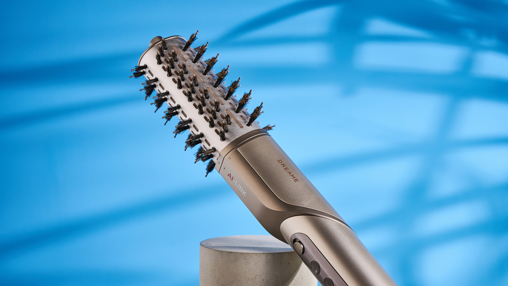 Dreame Dazzle air styler photographed in front of a blue background