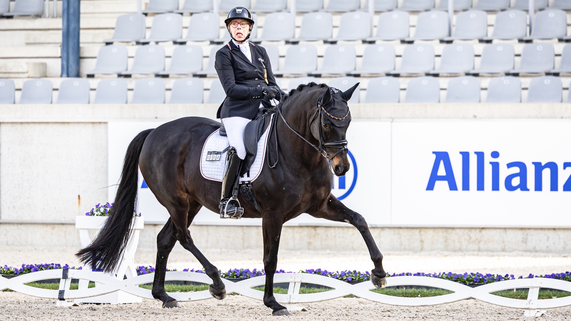 Heidemarie Dresing riding a bay horse in a dressage competition