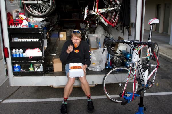 Mechanic Ralf Medlaff takes a late lunch with leftovers from the previous night's team dinner. As the sole mechanic at camp, Medlaff works long hours in the parking lot working on training camp bikes and preparing for the team's upcoming trip to Tour of Taiwan.