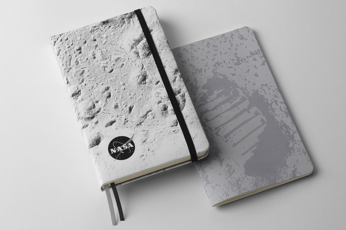NASA-inspired Limited Edition Notebooks from Moleskine. Left: Hardcover notebook with close up of the moon's surface on the front cover. Right: Softcover with Neil Armstrong's footprint on the moon on the front cover.