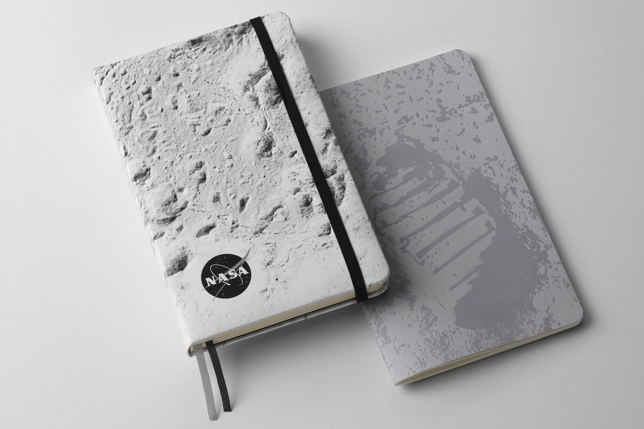 NASA-inspired Limited Edition Notebooks from Moleskine. Left: Hardcover notebook with close up of the moon's surface on the front cover. Right: Softcover with Neil Armstrong's footprint on the moon on the front cover.