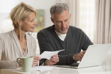 Couple paying bills on laptop