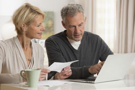 Couple paying bills on laptop