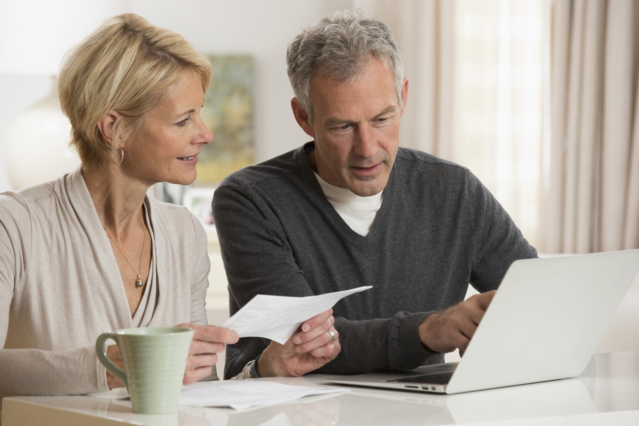 Couple paying bills on laptop