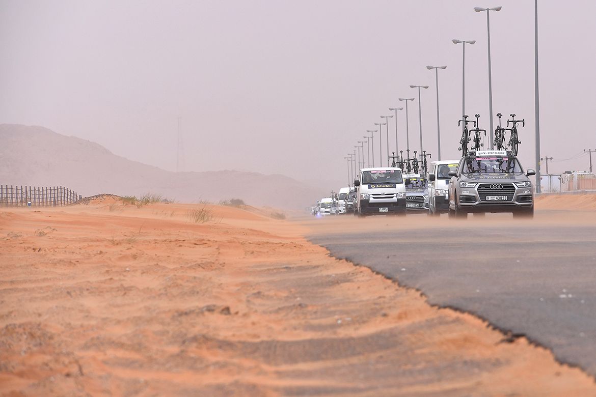 The cars drive through the desert