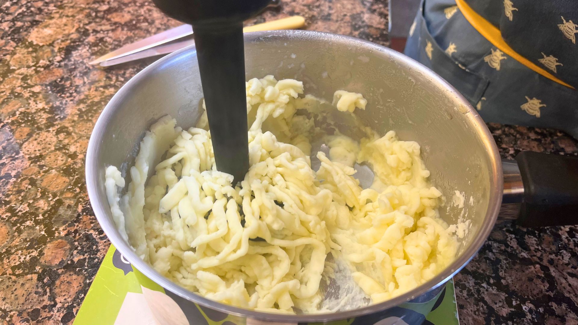 Tester Josephine Kennedy pictured using the Morphy Richards Handblender with Masher in her home kitchen