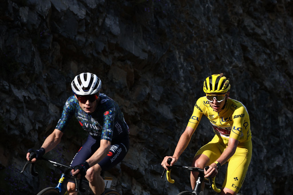 Team Visma - Lease a Bike team's Danish rider Jonas Vingegaard and UAE Team Emirates team's Slovenian rider Tadej Pogacar, wearing the overall leader's yellow jersey, cycle in the final ascent of the Col de la Couillole during the 20th stage of the 111th edition of the Tour de France cycling race, 132,8 km between Nice and Col de la Couillole, southeastern France, on July 20, 2024. (Photo by Anne-Christine POUJOULAT / AFP)