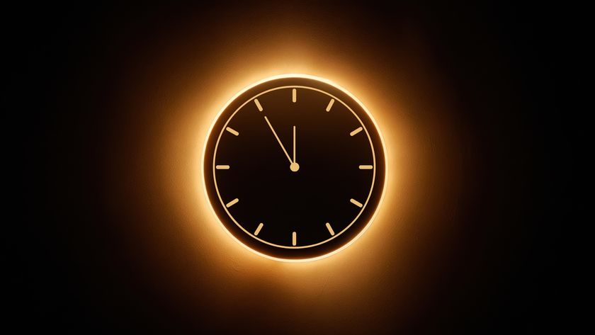 graphic of an annular solar eclipse with a ring of fire in the center of the image. There is a vector image of a clock inside this eclipse.