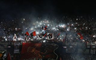 Fans of Newell's Old Boys light flares ahead of a game against River Plate in November 2019.