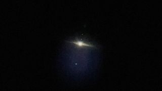 A view of jupiter and its moons in the sky, taken through the telescope