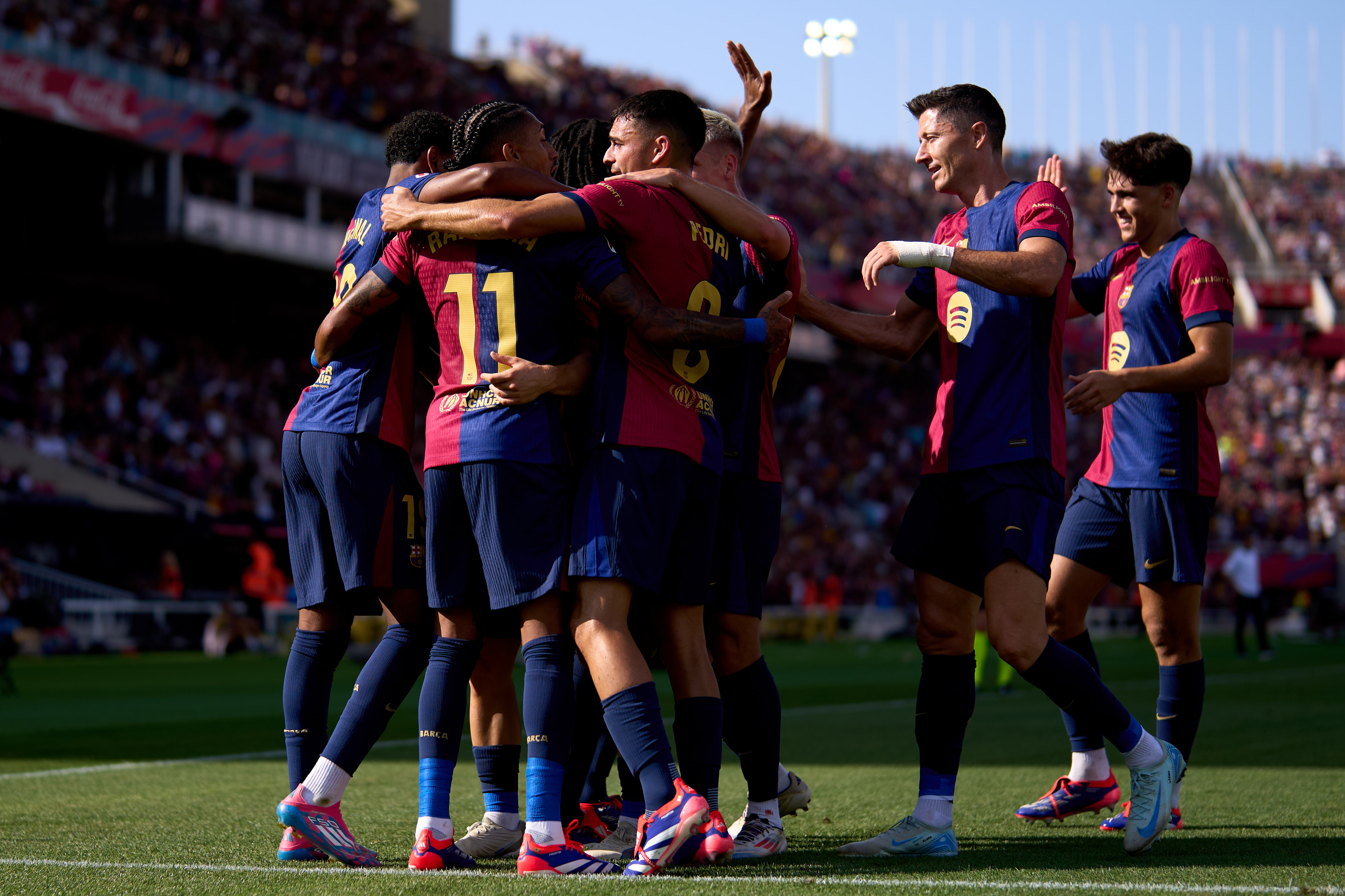 Raphinha celebrates with his Barcelona team-mates after scoring against Valladolid in La Liga in August 2024.