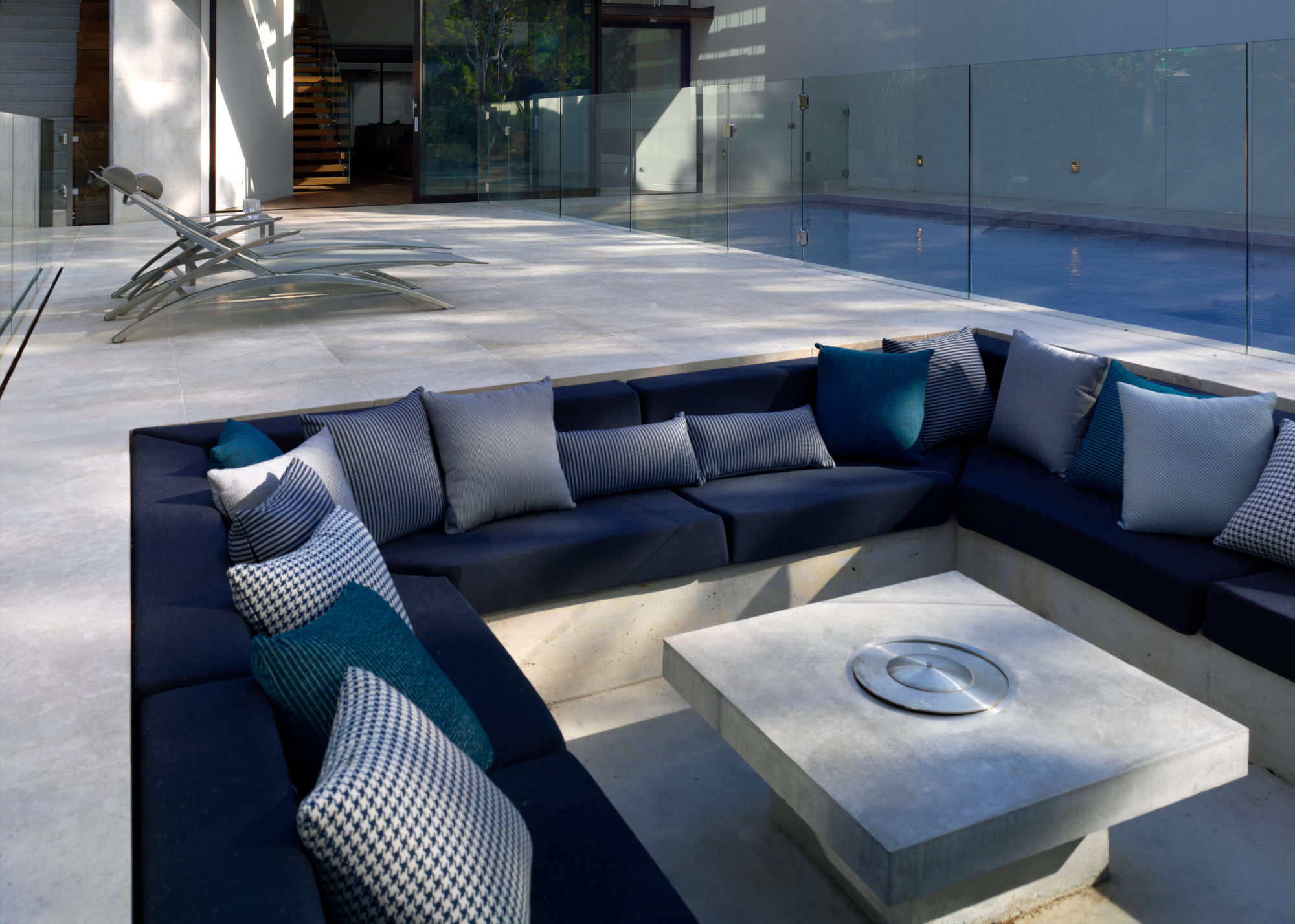 sunken firepit seating area in a modern garden