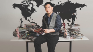 Bernard Chong sits on a desk